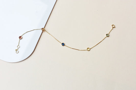 14K gold bracelet with rainbow sapphire bezels and bar links