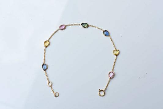 18K gold bracelet with single oval multi-color sapphire stations