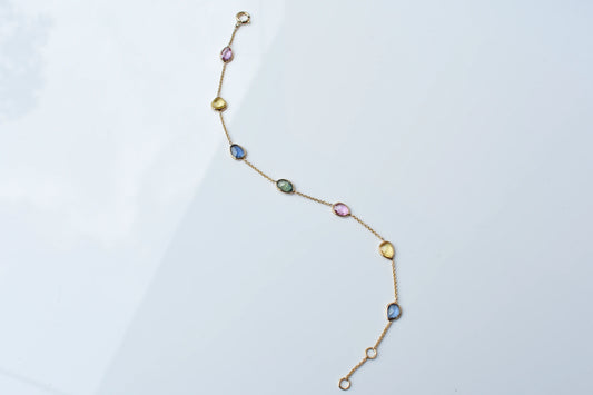 18K gold bracelet with single oval multi-color sapphire stations