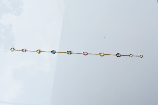 18K gold bracelet with single oval multi-color sapphire stations
