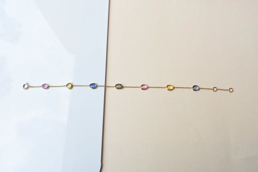 18K gold bracelet with single oval multi-color sapphire stations