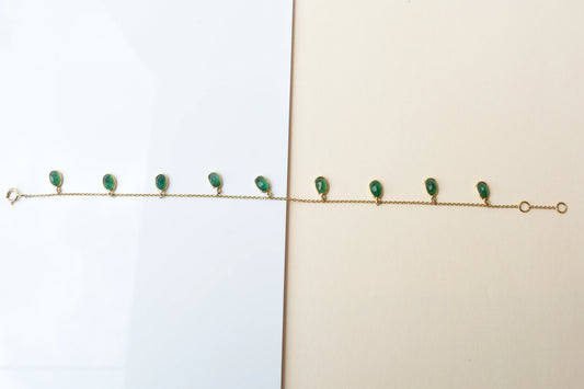 18K gold bracelet with oval emerald drops in fringe design