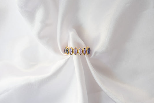 Marquise-cut tanzanite gemstone eternity ring in 14K gold with bezel setting
