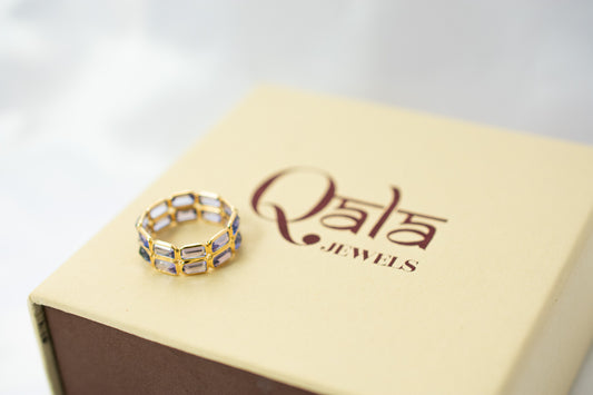 Baguette-cut tanzanite double-row eternity ring in 18K gold with bezel setting