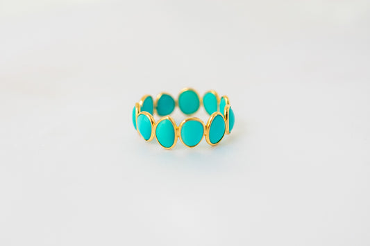 Oval cabochon turquoise gemstone eternity ring in gold with bezel setting