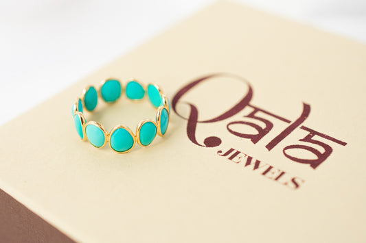 Oval cabochon turquoise gemstone eternity ring in gold with bezel setting