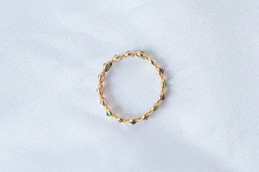 Oval-cut multicolor tourmaline gemstone eternity ring in 18K gold with bezel setting