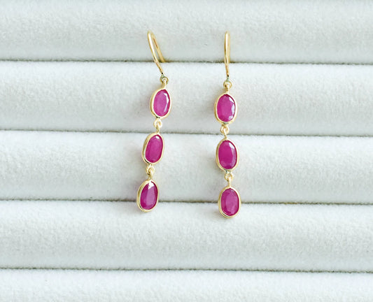 18K gold ruby station drop earrings with graduated oval rubies