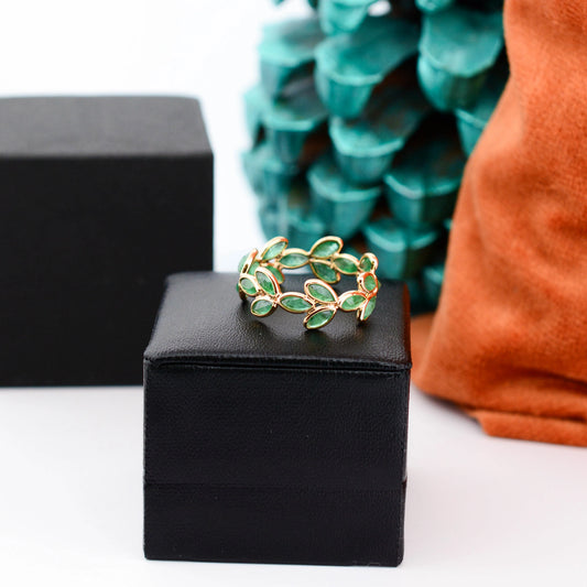 18K gold eternity ring with marquise-cut emeralds in a floral vine design