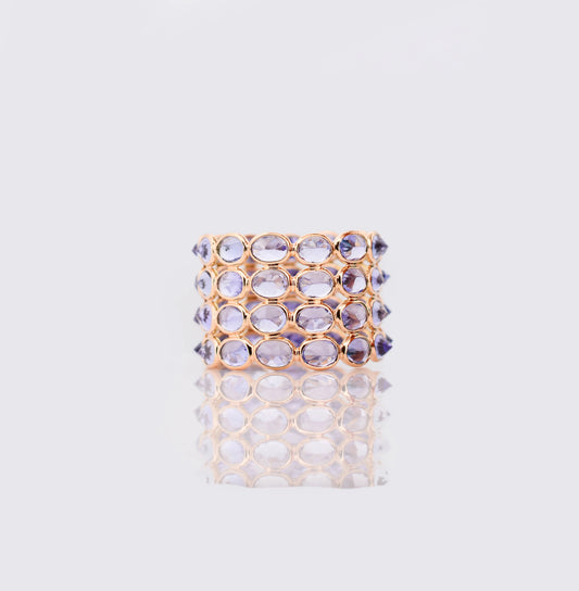 18K gold wide cocktail ring with bezel-set oval tanzanite in a honeycomb pattern