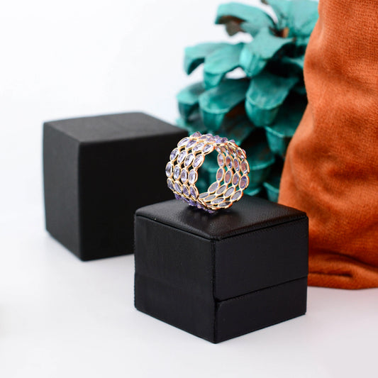 18K gold wide cocktail ring with bezel-set oval tanzanite in a honeycomb pattern