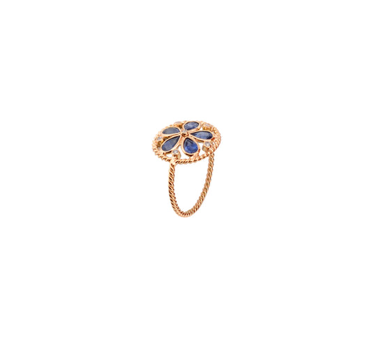 18K gold flower cluster ring with blue sapphire petals and a center diamond