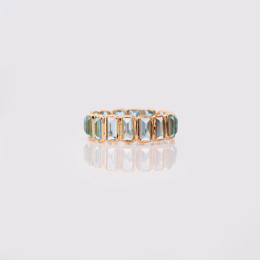 18K gold eternity ring with baguette-cut Swiss blue topaz stones