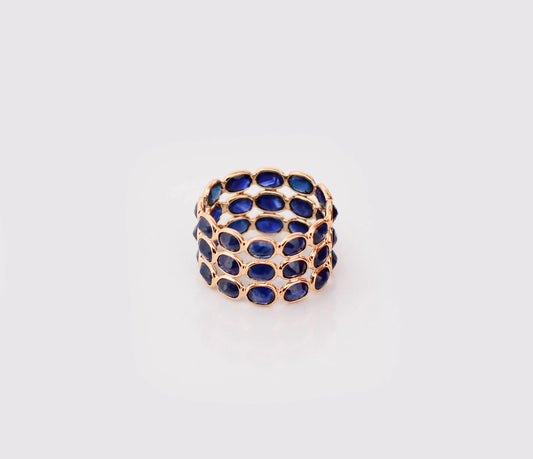 18K gold wide cocktail ring with three rows of bezel-set blue sapphires