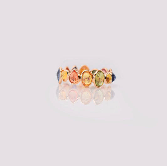 18K gold eternity ring with mixed-cut rainbow sapphire stones