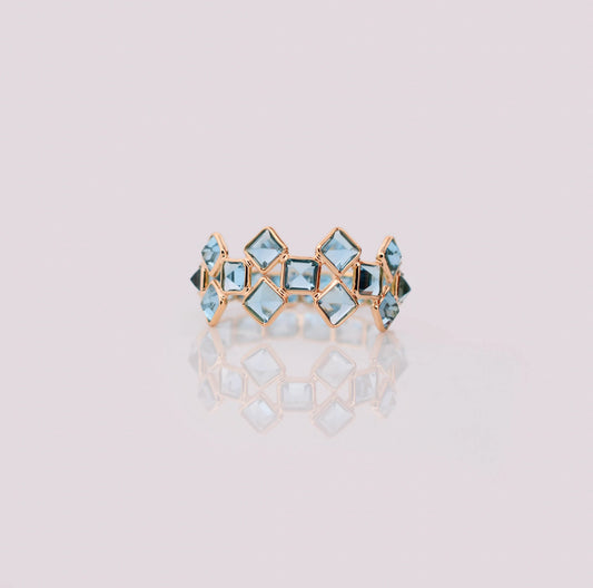 18K gold eternity ring with Swiss blue topaz in a mosaic checkerboard pattern