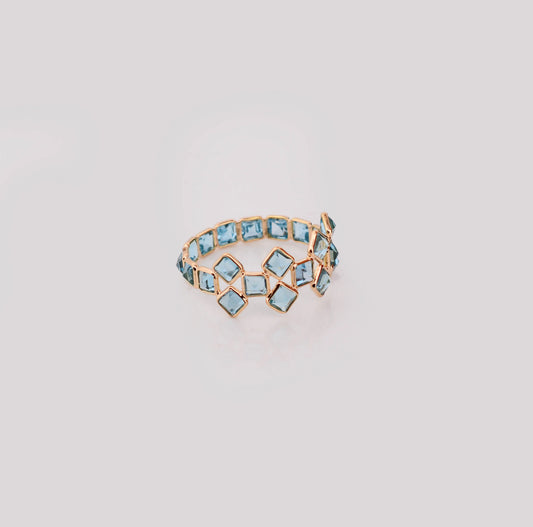 18K gold eternity ring with Swiss blue topaz in a mosaic checkerboard pattern