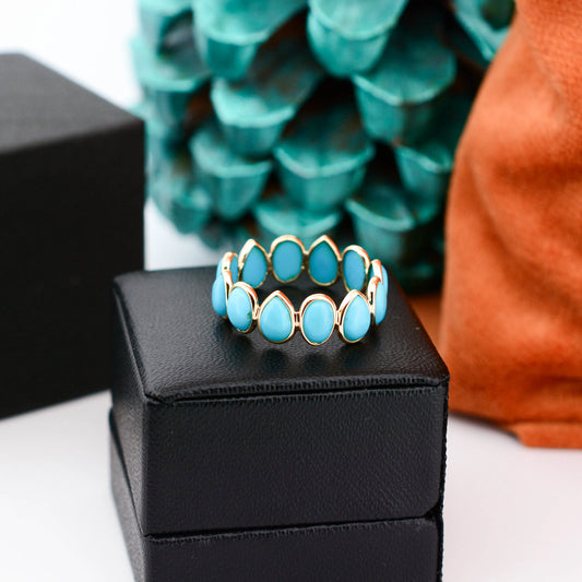 18K gold eternity ring with bezel-set pear and oval turquoise cabochons