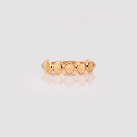 18K gold eternity ring with bezel-set opals and diamond accents