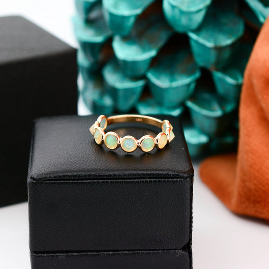 18K gold eternity ring with bezel-set opals and diamond accents