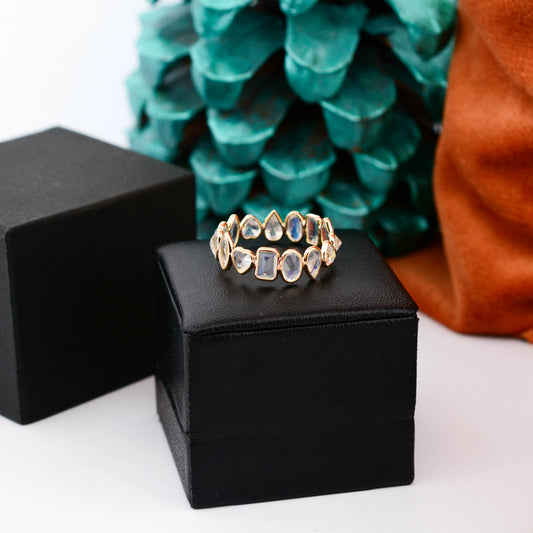 18K gold eternity ring with mixed-cut rainbow moonstone stones