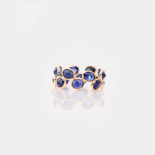 18K gold eternity ring with bezel-set oval-cut blue sapphires