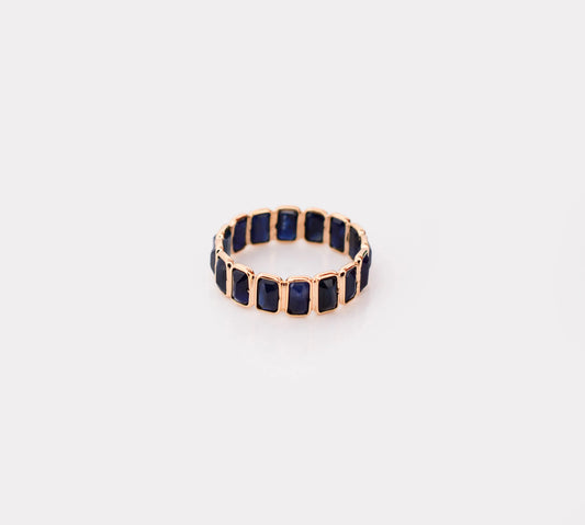 18K gold eternity ring with bezel-set emerald-cut blue sapphires