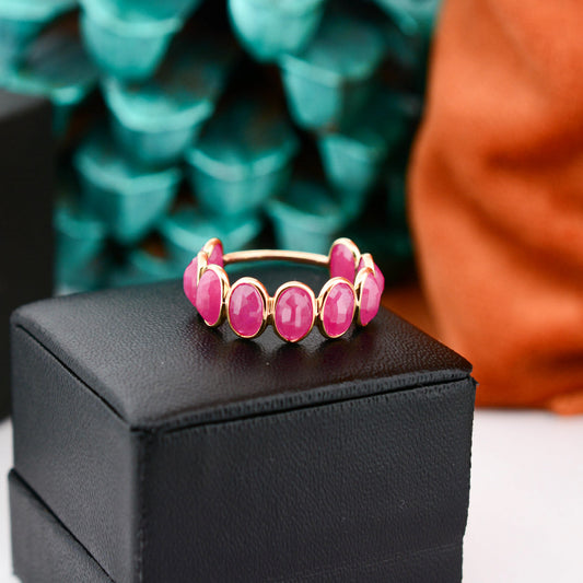 18K gold eternity ring with bezel-set oval-cut rubies