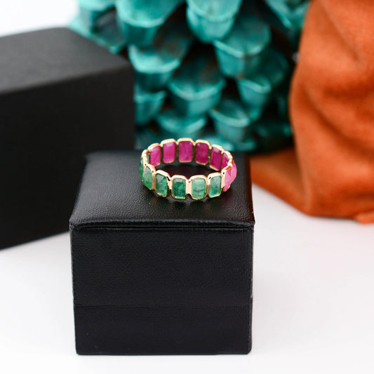 18K gold eternity ring with emerald-cut emerald and ruby stones in a two-tone design