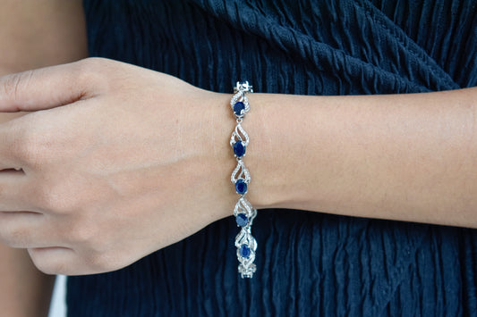 Blue gemstone oval tennis bracelet in 925 silver with pavé accents