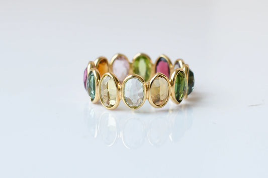 Oval-cut multicolor tourmaline double-row eternity ring in 18K gold