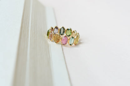 Oval-cut multicolor tourmaline double-row eternity ring in 18K gold