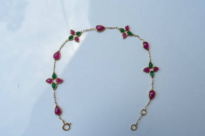 Gold bracelet with ruby and emerald quatrefoil clusters