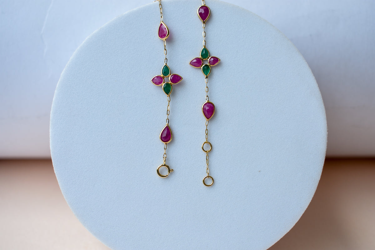 Gold bracelet with ruby and emerald quatrefoil clusters