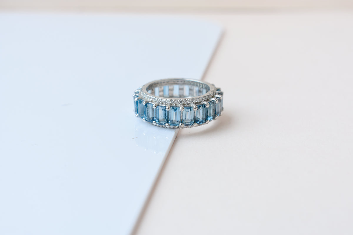 Sky blue topaz wide emerald-cut eternity ring in 925 silver