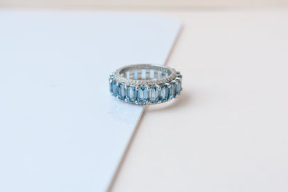 Sky blue topaz wide emerald-cut eternity ring in 925 silver