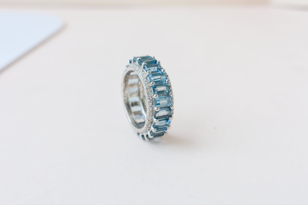 Sky blue topaz wide emerald-cut eternity ring in 925 silver