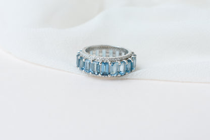 Sky blue topaz wide emerald-cut eternity ring in 925 silver