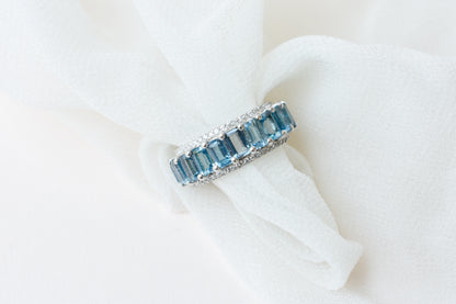 Sky blue topaz wide emerald-cut eternity ring in 925 silver