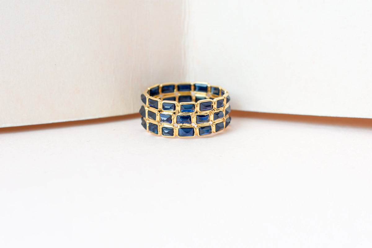 Baguette-cut blue sapphire three-row eternity ring in 18K gold