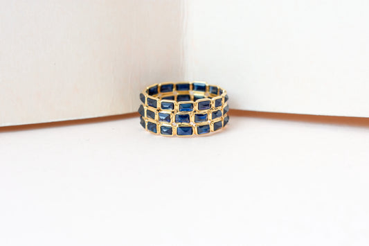 Baguette-cut blue sapphire three-row eternity ring in 18K gold