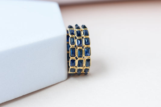 Baguette-cut blue sapphire three-row eternity ring in 18K gold