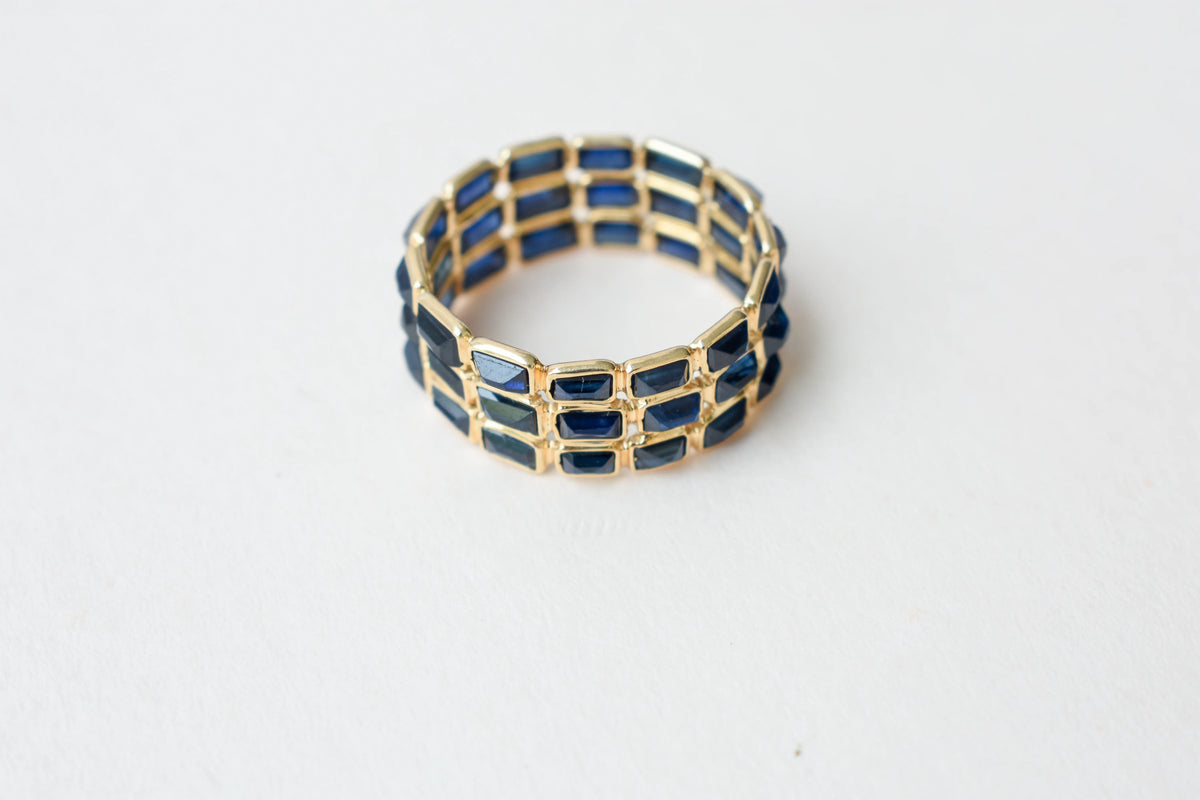 Baguette-cut blue sapphire three-row eternity ring in 18K gold