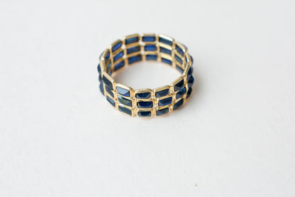 Baguette-cut blue sapphire three-row eternity ring in 18K gold