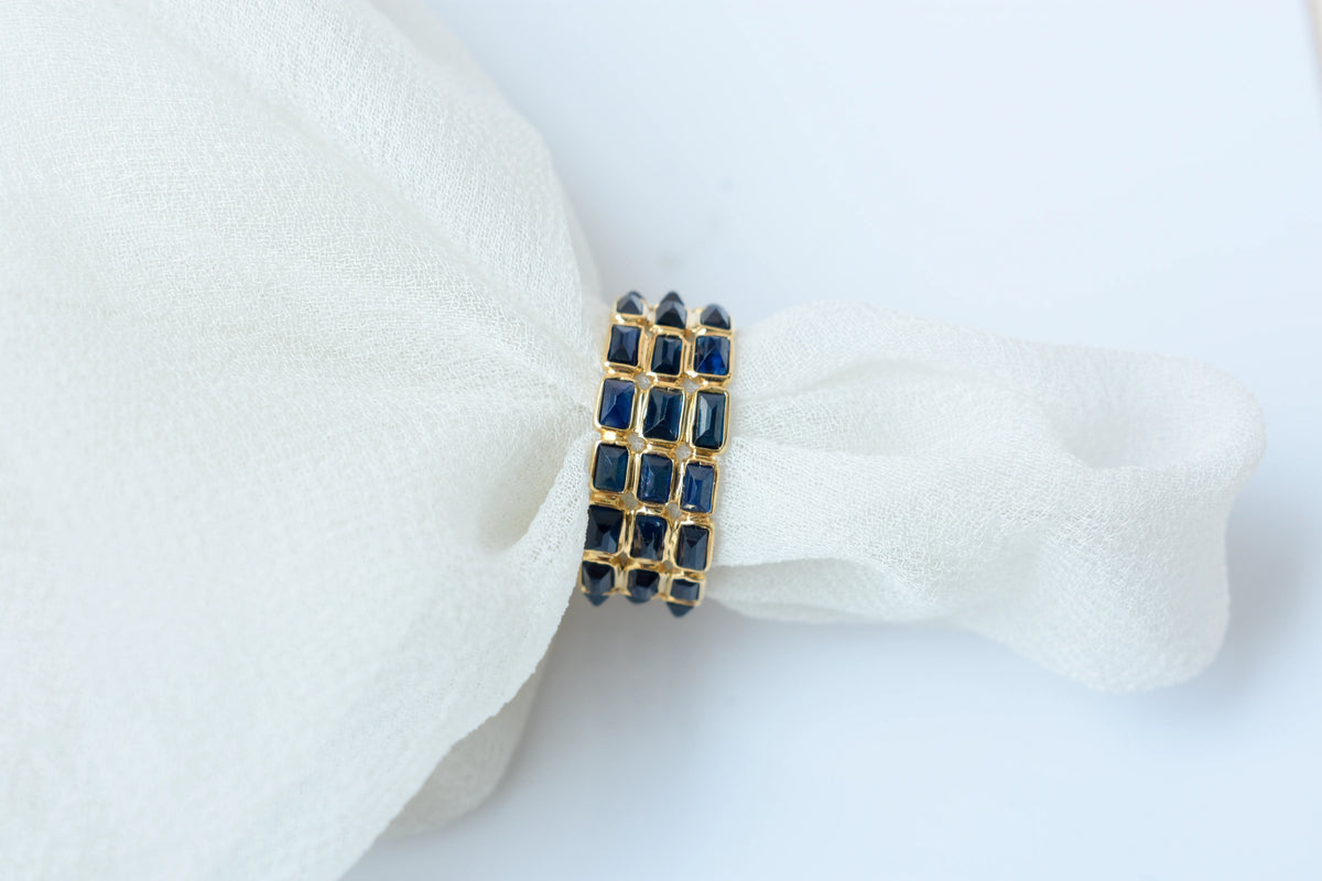 Baguette-cut blue sapphire three-row eternity ring in 18K gold