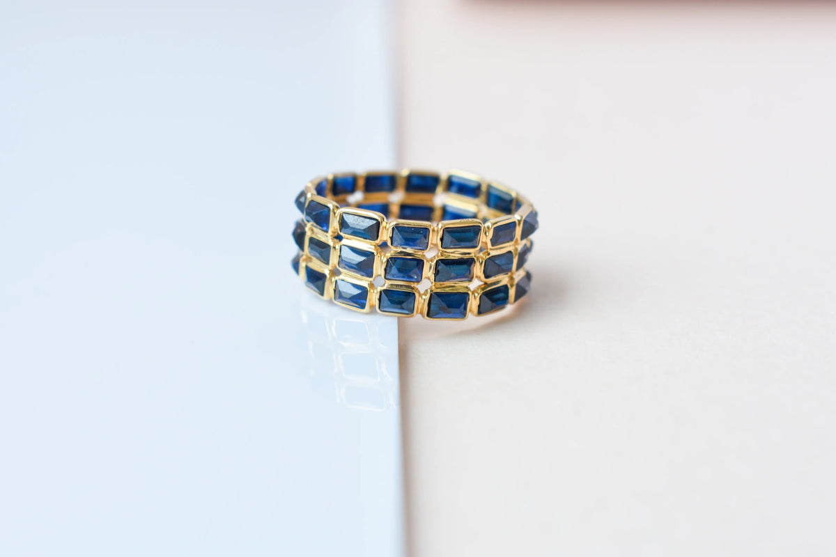 Baguette-cut blue sapphire three-row eternity ring in 18K gold