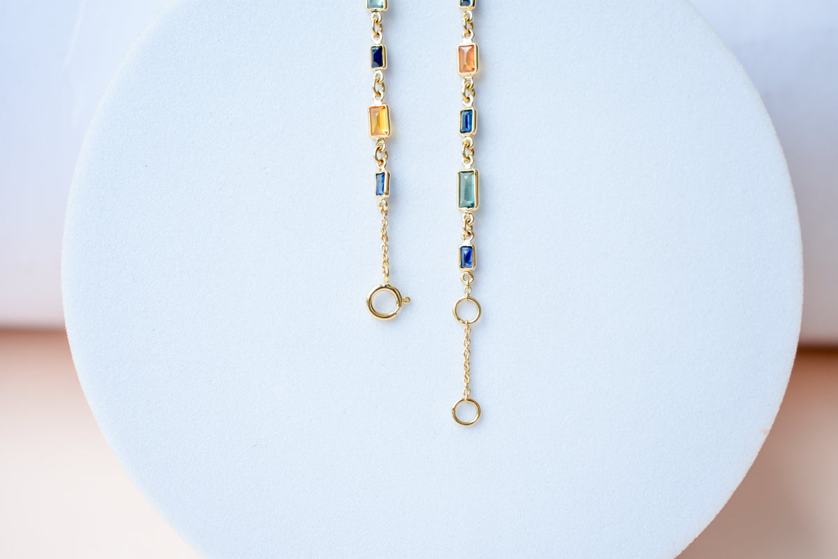 18K gold paperclip chain bracelet with multi-coloured sapphire stations