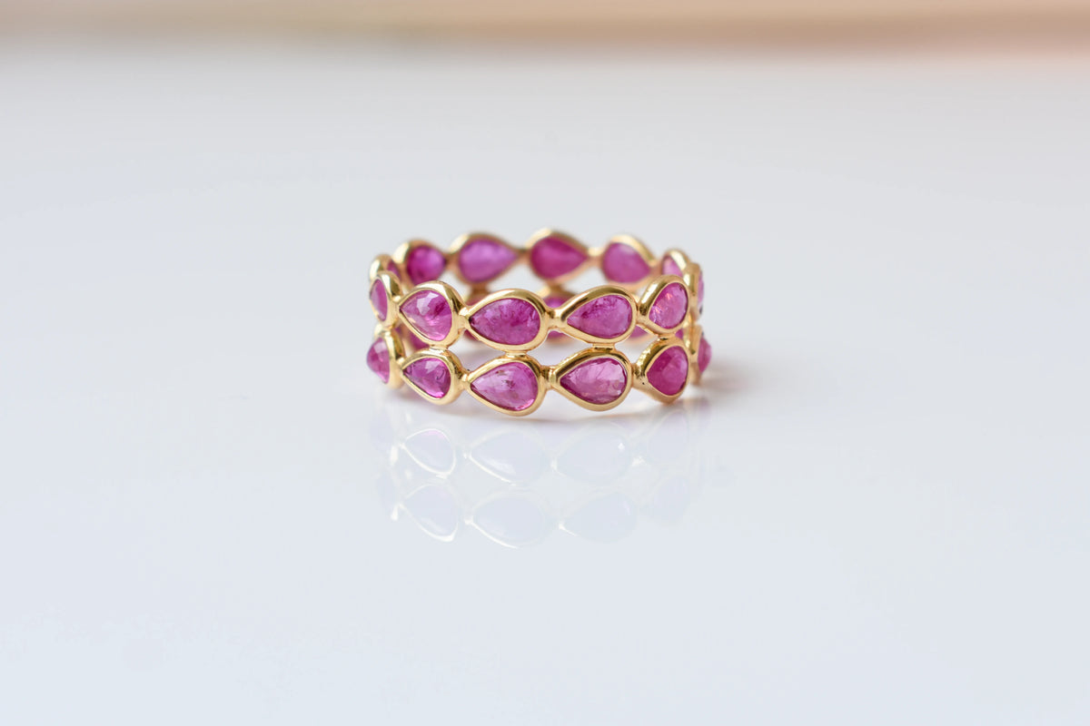 Pear-cut ruby woven double-row eternity ring in 18K gold
