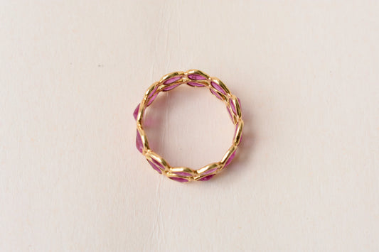 Pear-cut ruby woven double-row eternity ring in 18K gold