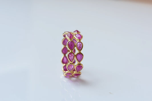 Pear-cut ruby woven double-row eternity ring in 18K gold